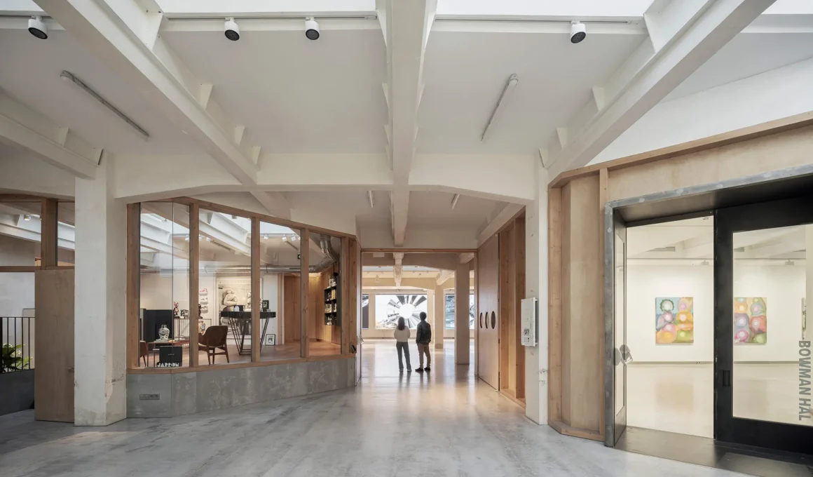 Interior view of SOLO CSV Madrid showing the timber circulation loop and white industrial ceiling.