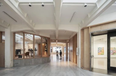 Interior view of SOLO CSV Madrid showing the timber circulation loop and white industrial ceiling.