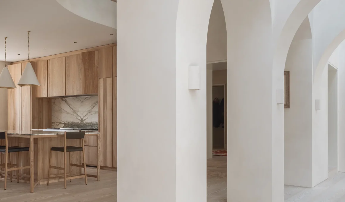 Sculpted white arches and bespoke ash kitchen cabinetry in West London House.