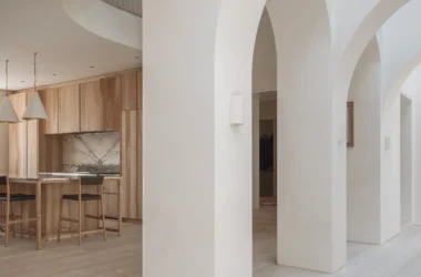 Sculpted white arches and bespoke ash kitchen cabinetry in West London House.