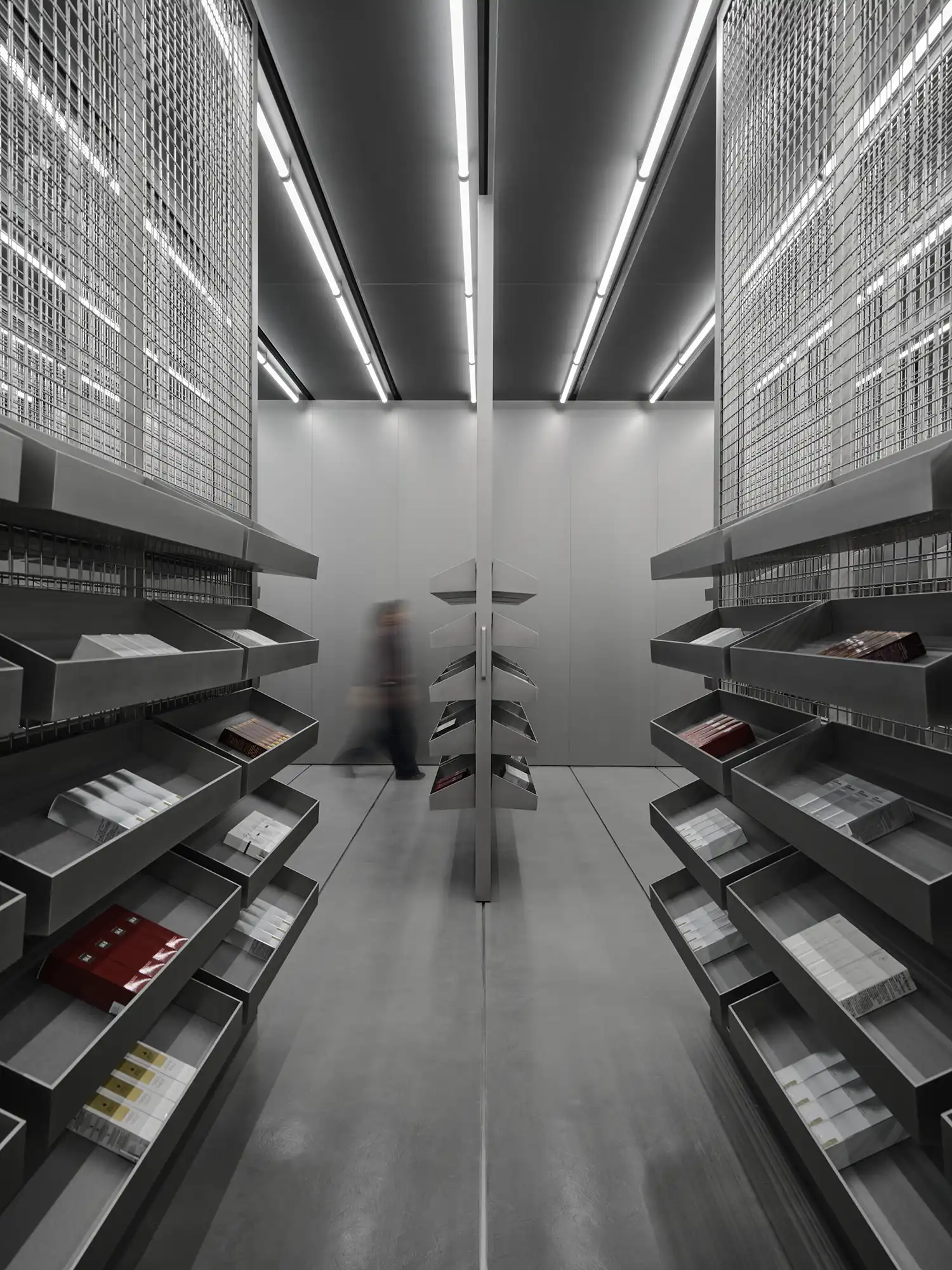 Narrow aisle of metal mesh storage panels and tilted display trays in HARMAY Beijing.