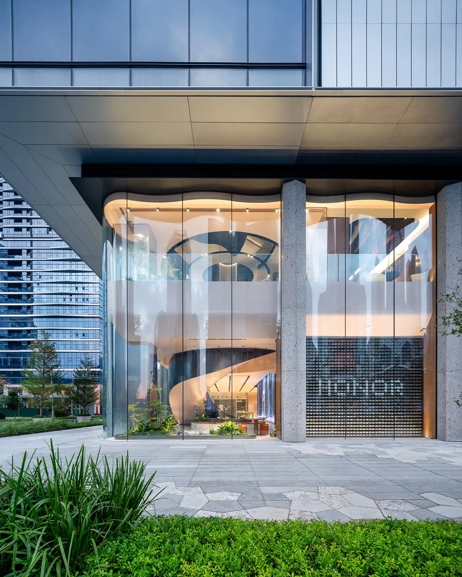 Close-up of HONOR store facade with integrated planter and massive LED screens showing digital art