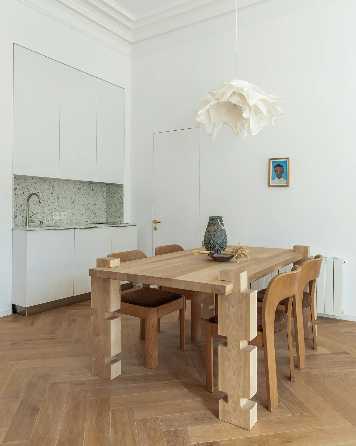 ELEMENT Dining Table by Idaaf Architects in a white minimalist kitchen.