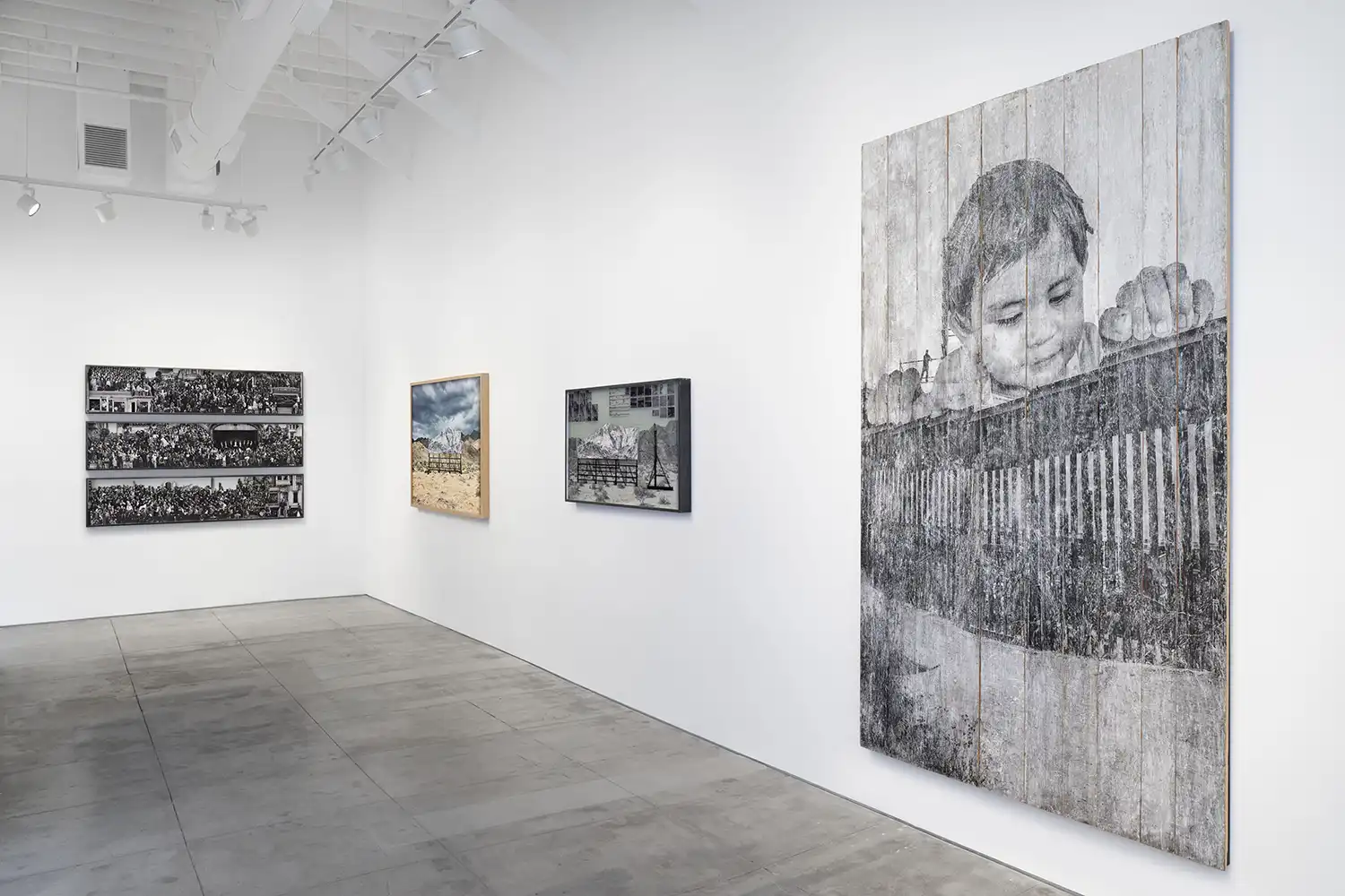 Exhibition view of JR's solo show 'Horizons' at Perrotin Los Angeles, featuring monumental ink-on-wood installations and photographic works.