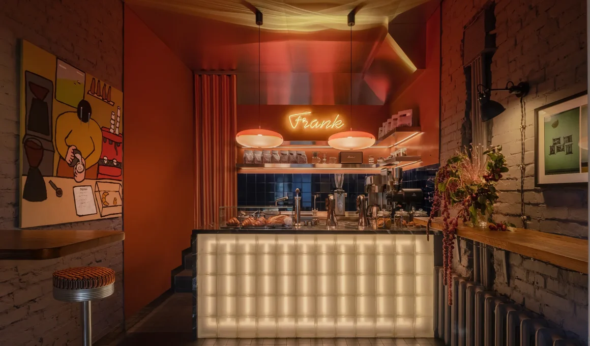 Frank cafe interior in Kyiv featuring a glowing glass block counter and glossy red walls.
