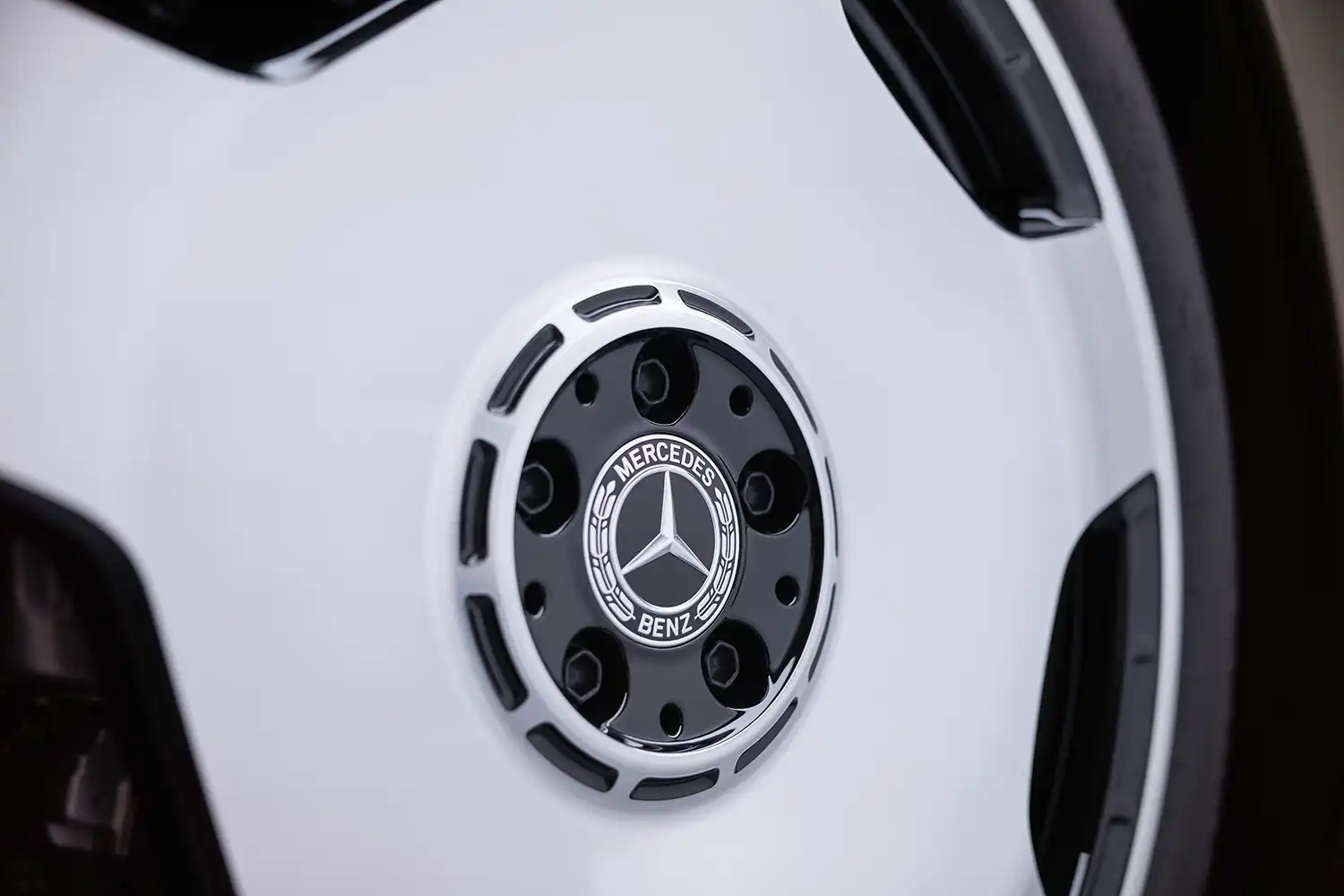 Close-up of a multi-spoke alloy wheel with the Mercedes-Benz star on a black center cap.