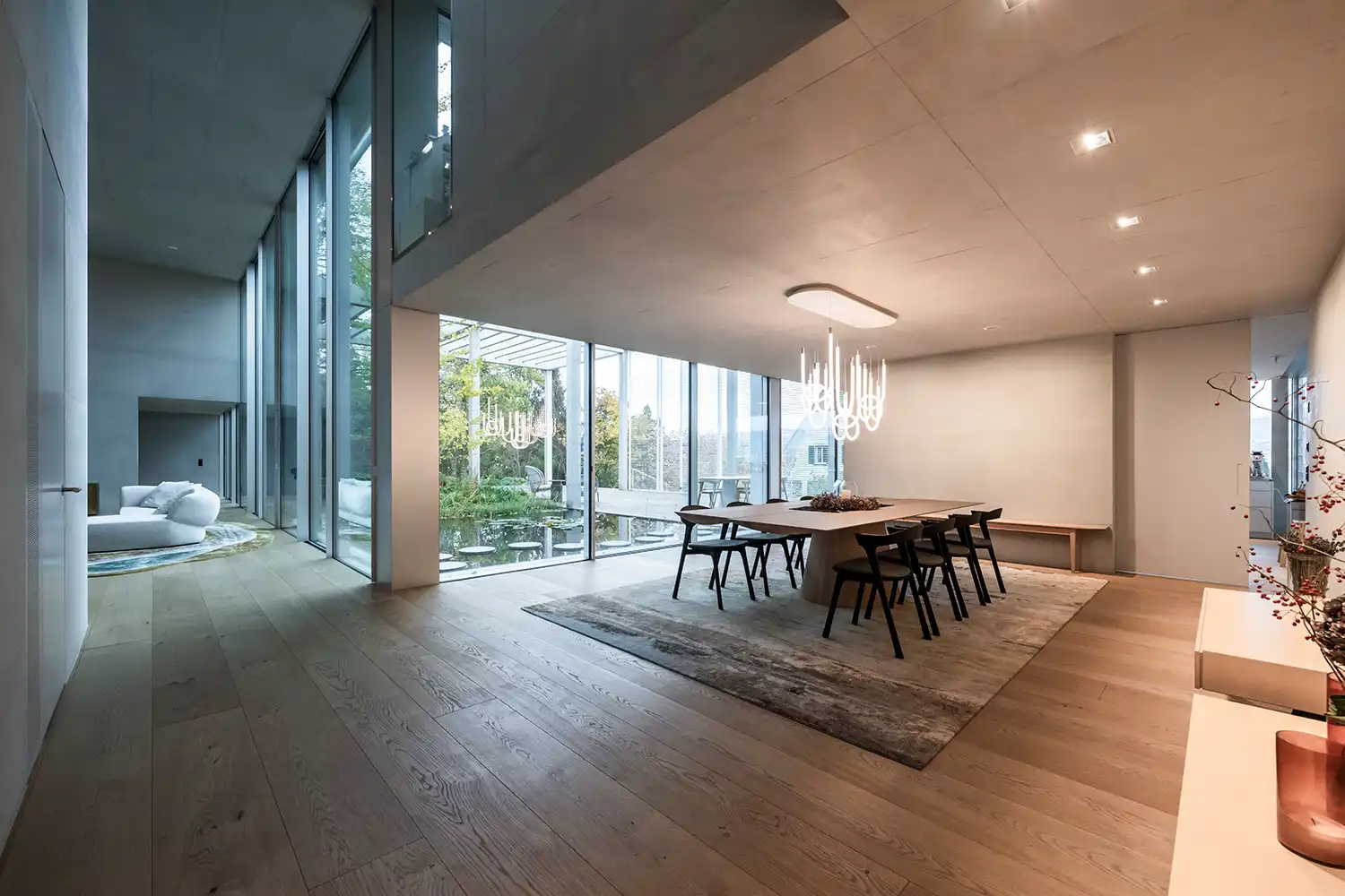 Open plan dining area modern LED pendant design NOA Network of Architecture Atrium Villa