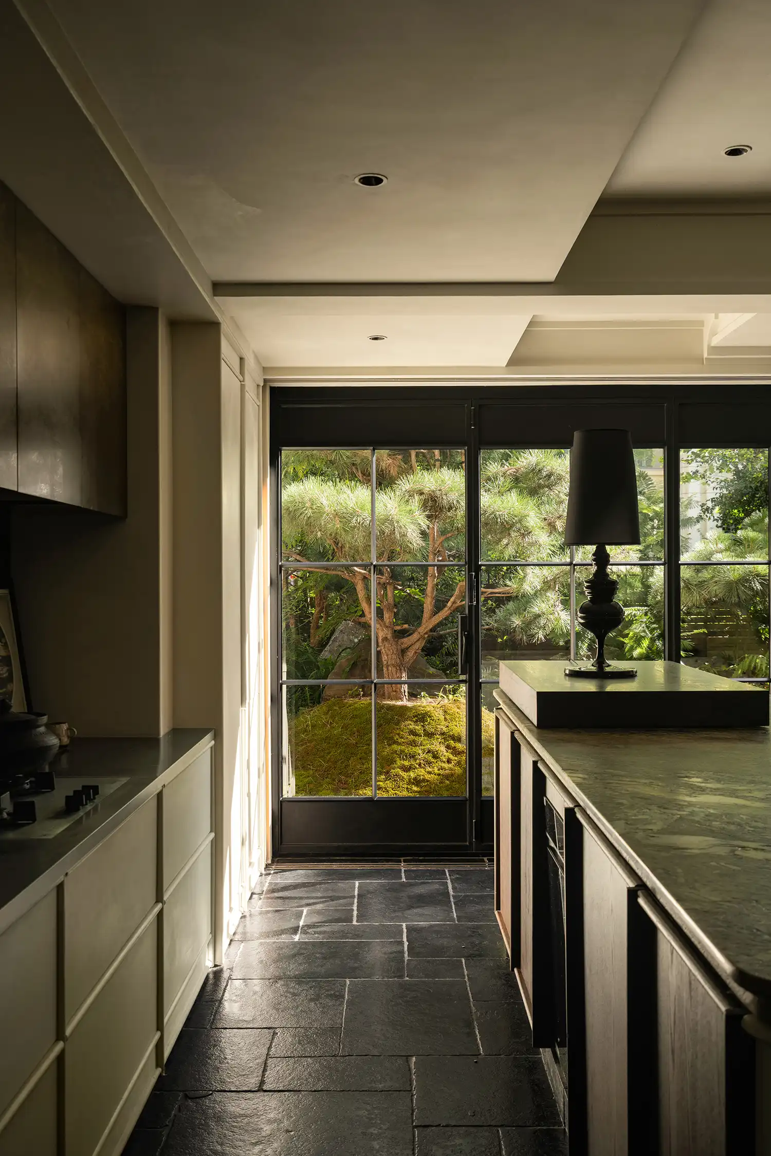 The kitchen ceiling features gradient stainless steel, referencing old-time kitchens where smoke stained the walls.