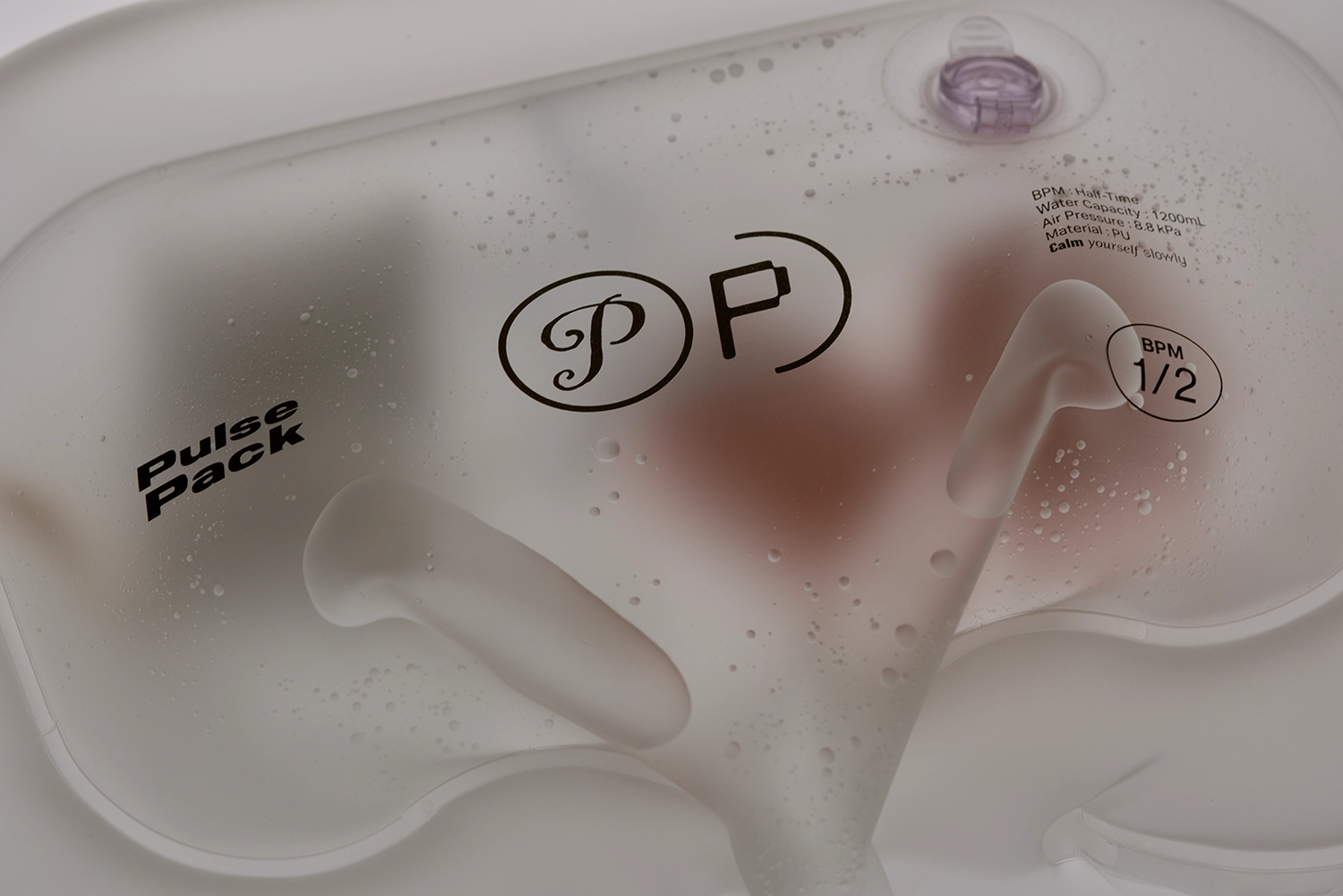 Close-up of the Pulse Pack surface with water droplets, showing the "Pulse Pack" logo and technical specifications printed on the material.