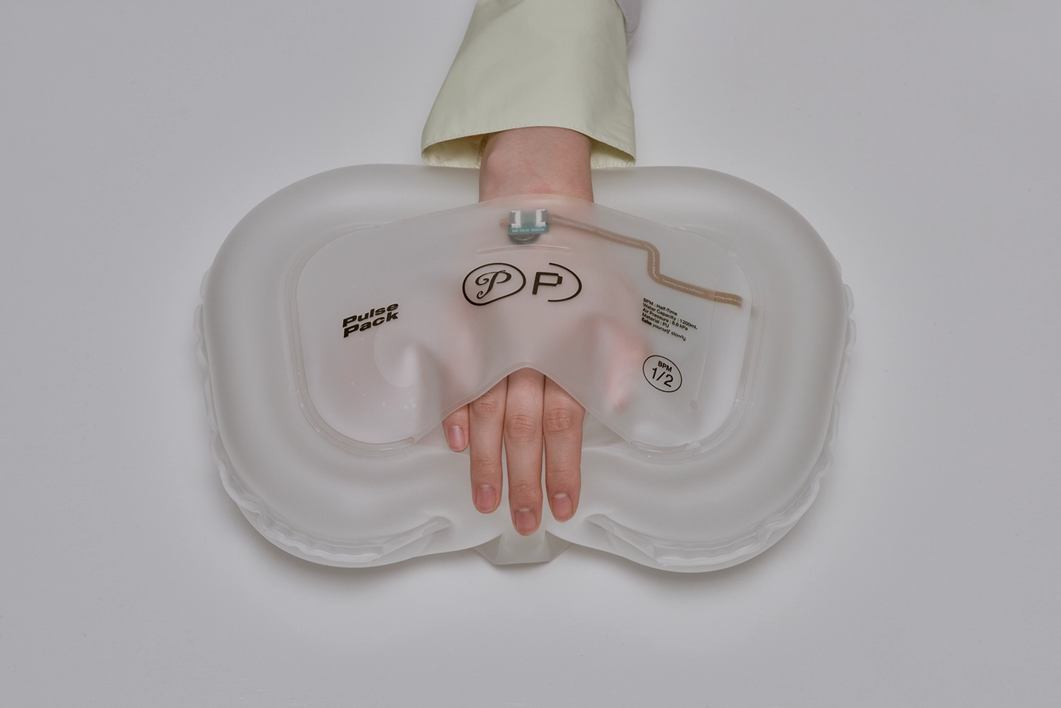 Top view of a hand resting inside the ergonomic grip of the Pulse Pack against a clean white background.