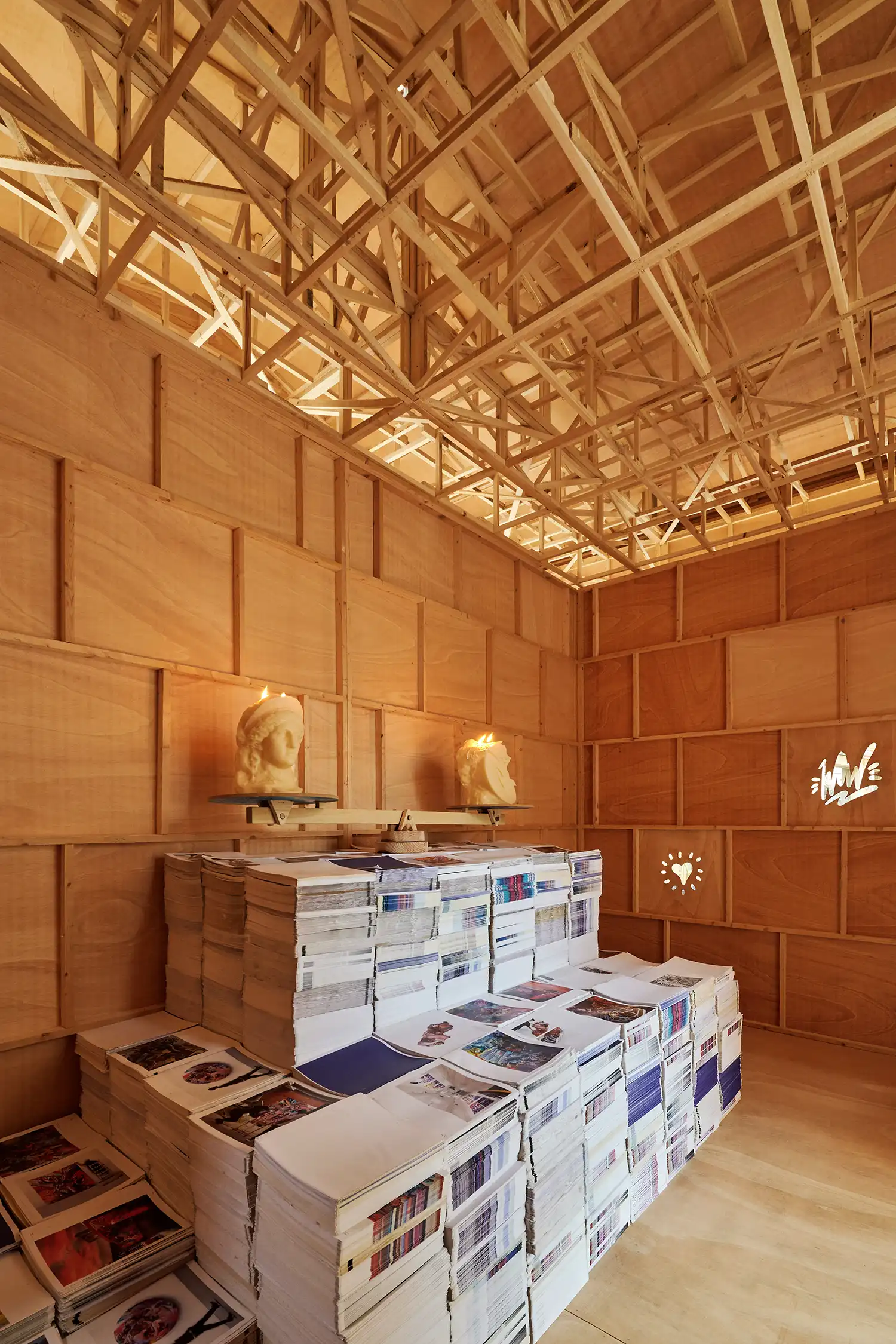 Interior view of the wooden temple structure showing the timber truss ceiling.