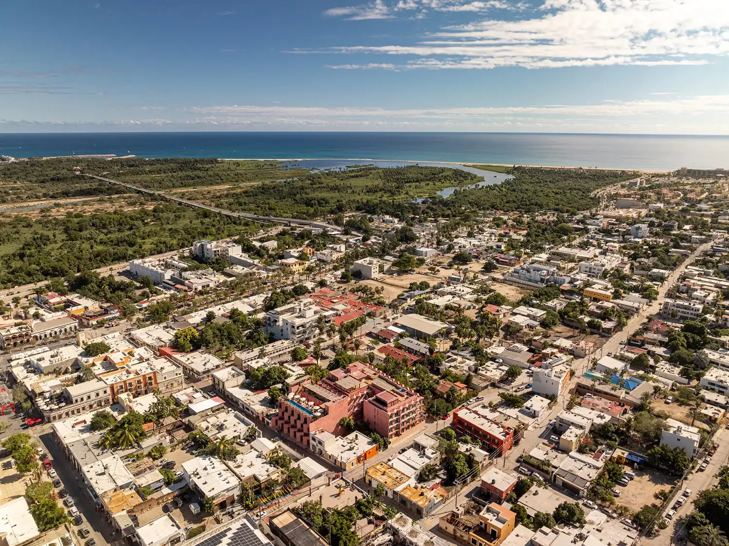Aerial drone shot of San José del Cabo showing the hotel's location near the coast.