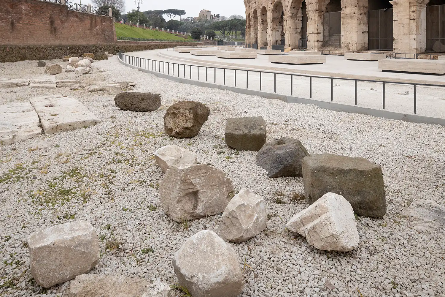 Archaeological excavation area with tuff blocks and historical debris at the Colosseum