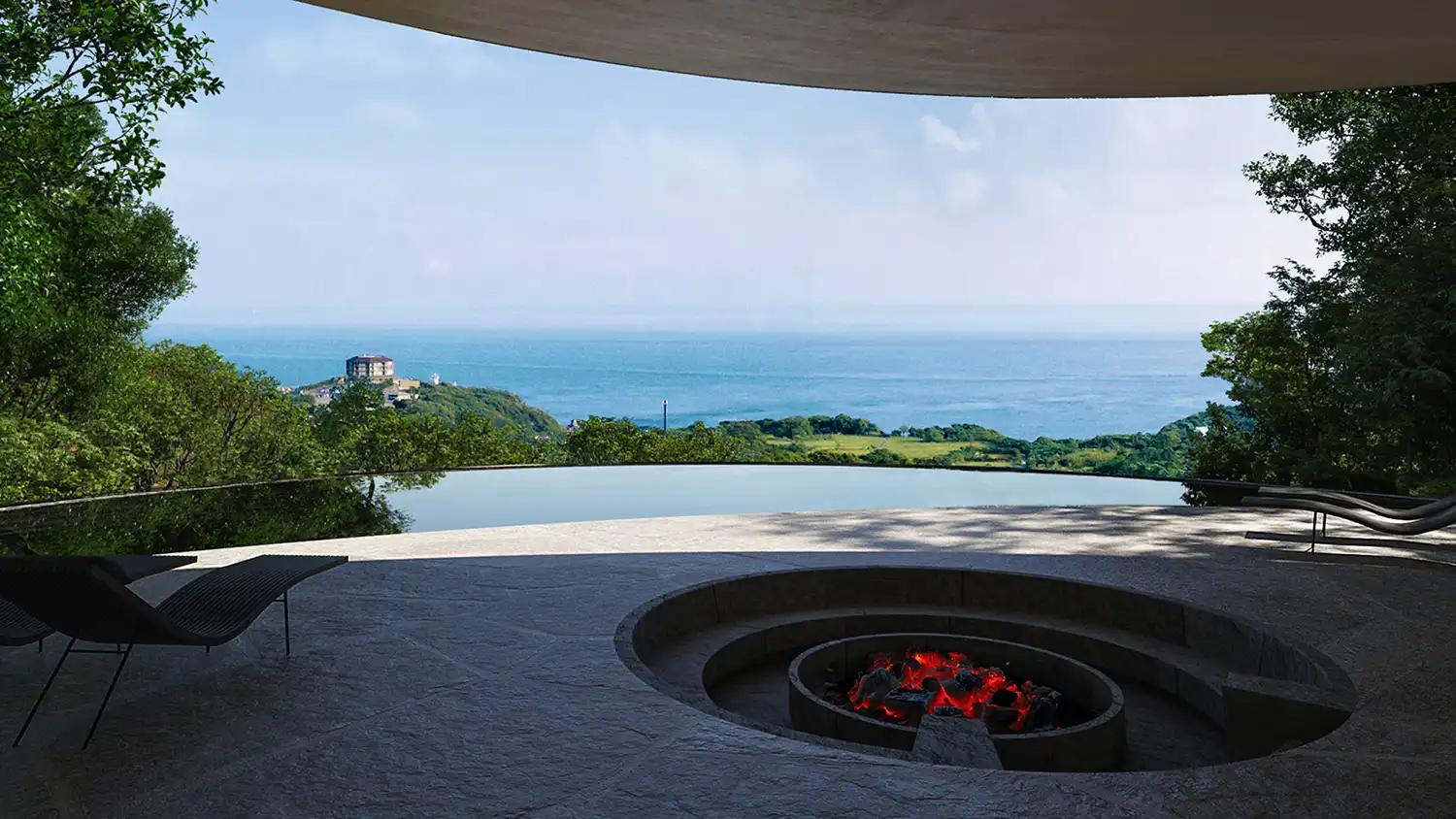 An interior perspective looking out from a cave-like concrete room onto a sunlit stone terrace with a sunken firepit and chairs, overlooking a tranquil infinity pool and the ocean with a distant clifftop building under a blue sky.