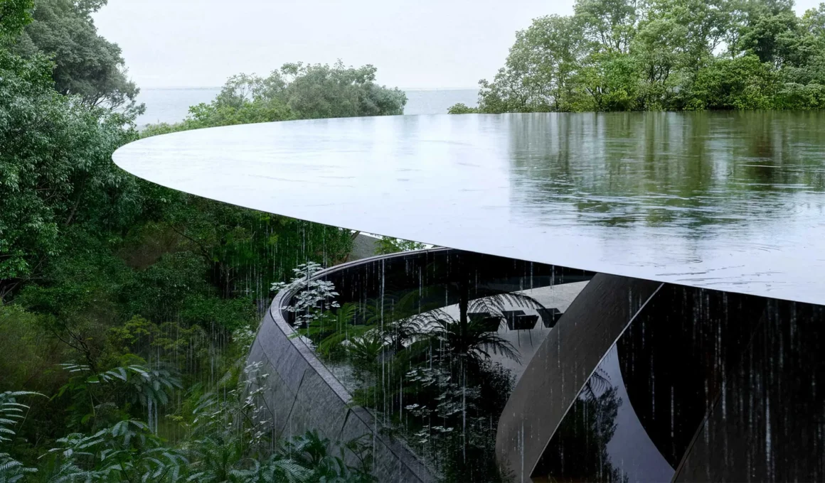 A detailed view of heavy rain falling from a large, sleek, cantilevering circular roof structure over a dark, curved concrete base set in dense green foliage, looking out towards the ocean.