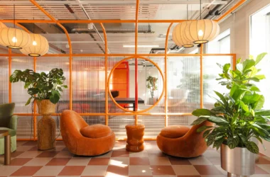 Studio Aisslinger Zurich workspace with orange metal framing and velvet chairs