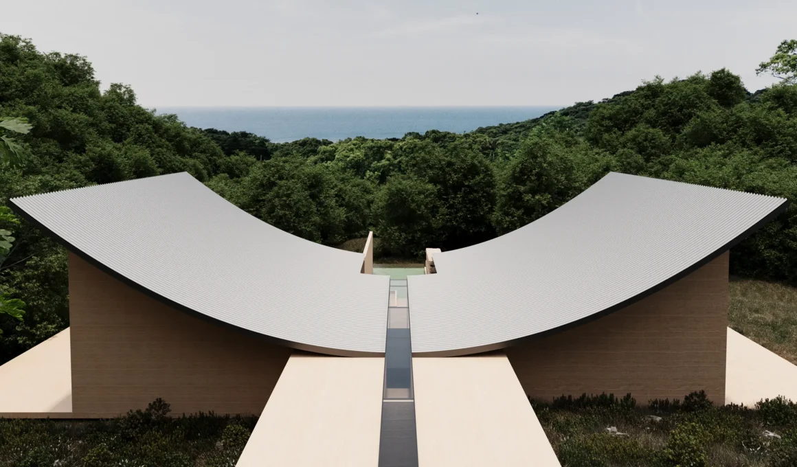 Wide aerial view of Villa Sensorium’s symmetrical curved roof split by a central glass axis looking toward the sea.