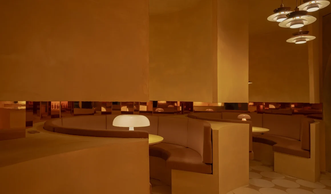 Interior of Cateto Club in Marbella featuring curved alcoves and retro lighting.