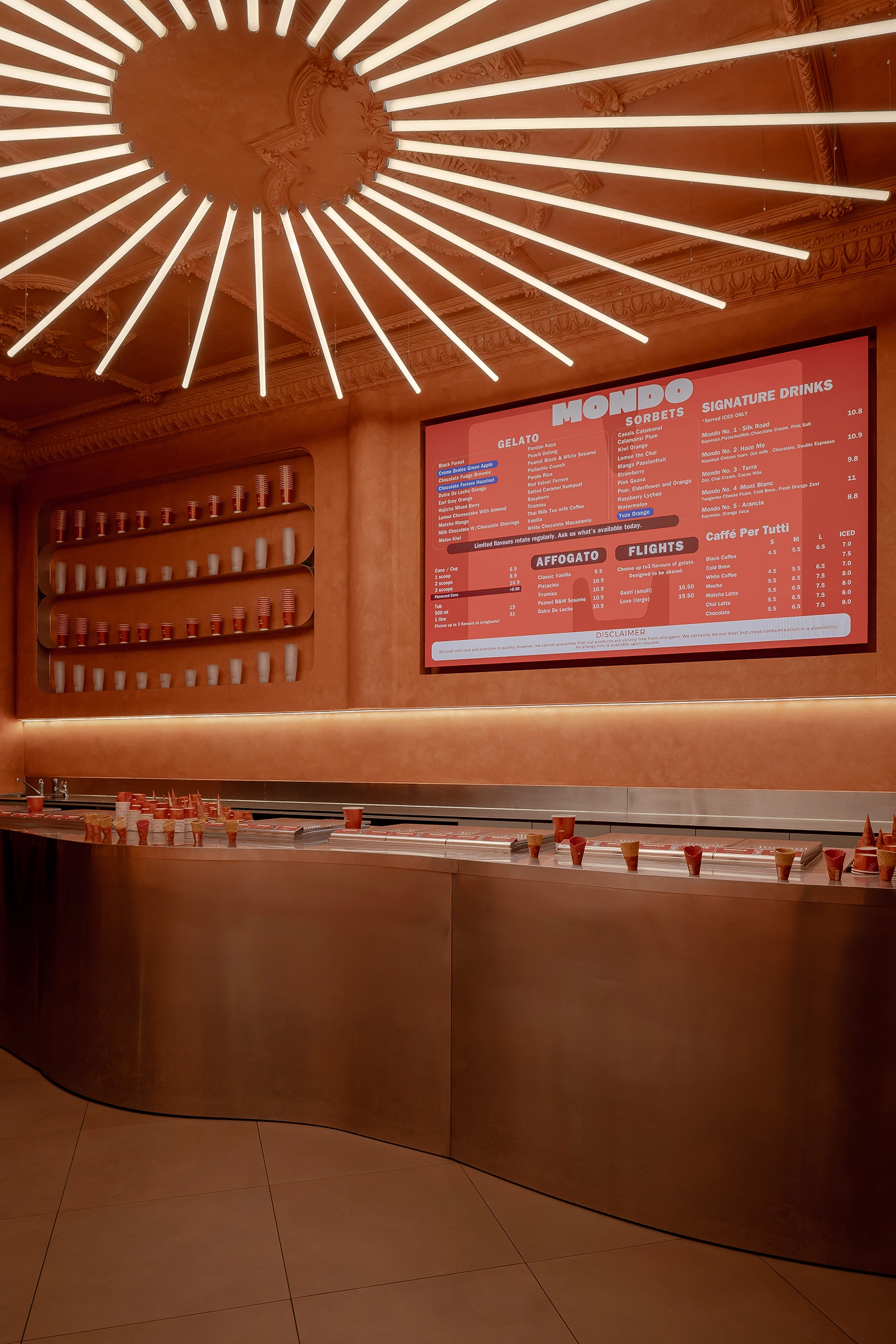Frontal view of the gelato service area with a digital menu listing flavors like Black Forest, Sorbet, and Signature Drinks.