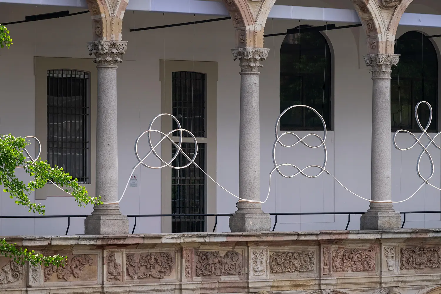 Close-up of the aluminum support and LED strip forming a simple knot geometry in the East Loggia.