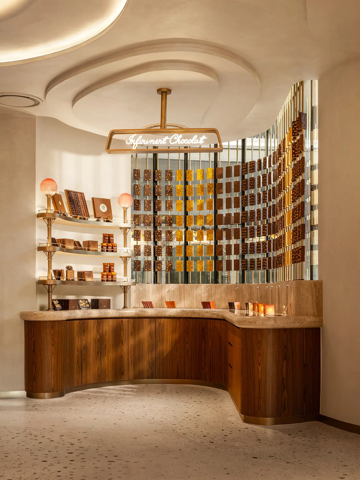 Chocolate display area with "Infiniment Chocolat" signage and backlit shelves.