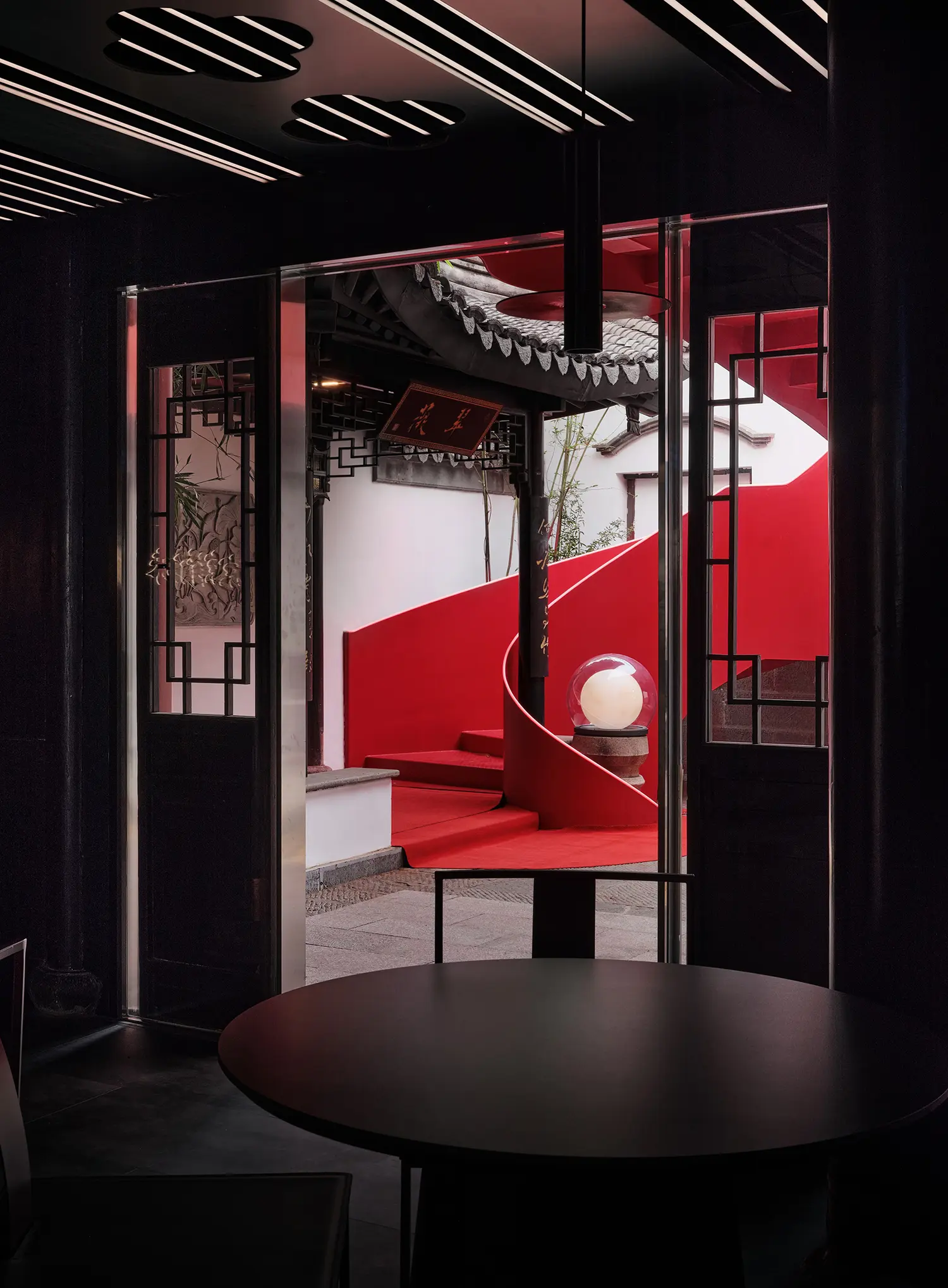 View from inside the Red Lobster restaurant looking out toward the red staircase through a traditional door.