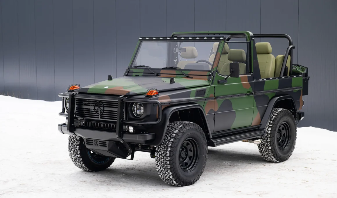 Three-quarter front view of a camouflage 1991 Mercedes-Benz G-Wagen Wolf by EMC parked in snow.