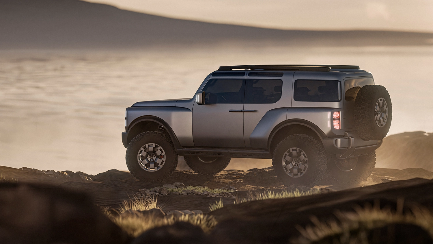 Profile view of the Hyundai Boulder Concept SUV against a misty mountain horizon at sunset.