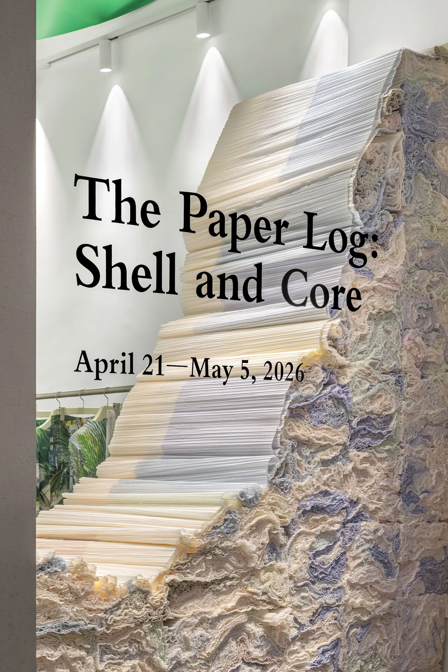 Extreme close-up of the exhibition title "The Paper Log: Shell and Core" overlaid on a textured paper structure.