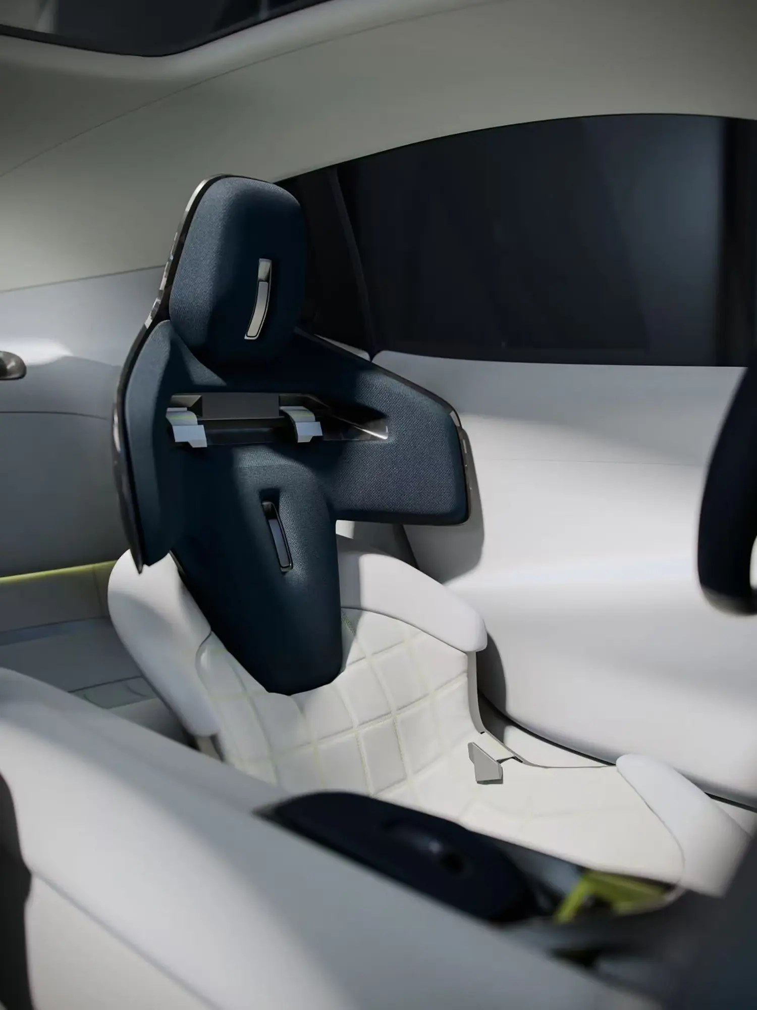 Detailed shot of the sculpted driver's seat featuring technical fabric and a modular headrest design.