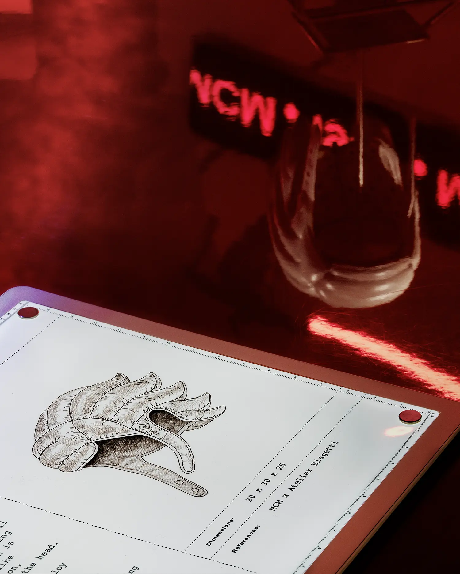 A technical drawing of a padded helmet on a lightbox next to a physical prototype.
