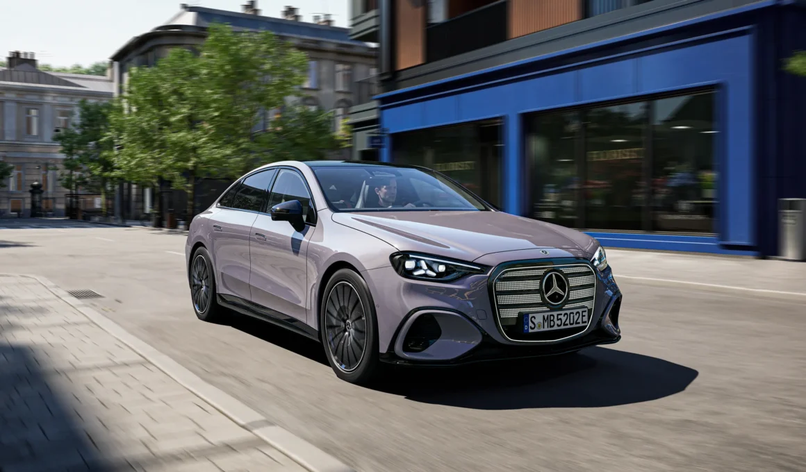 Front three-quarter view of the electric Mercedes-Benz C-Class in a minimalist concrete architectural setting.