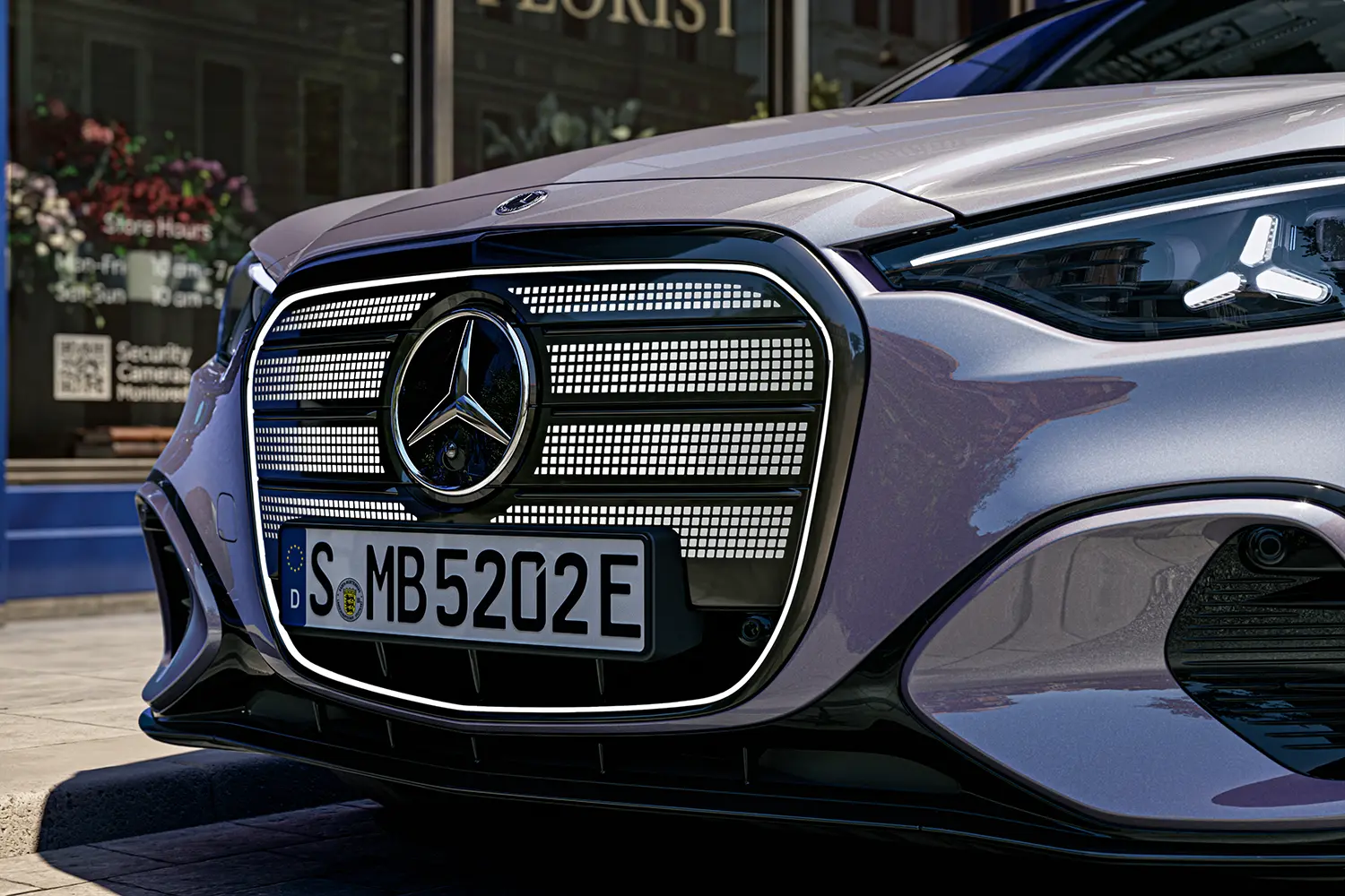 Close-up detail of the front grille featuring the Mercedes-Benz logo and back-lit star pattern.
