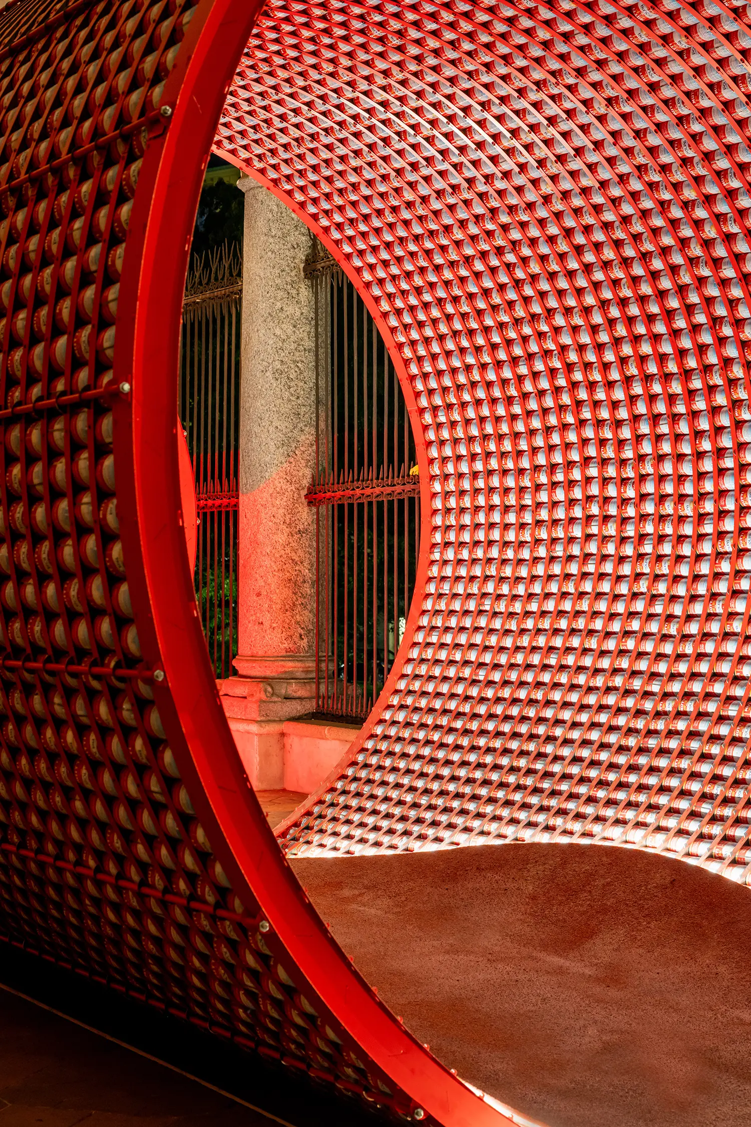 Close-up of the curved interior wall of tomato cans meeting a textured brown floor.