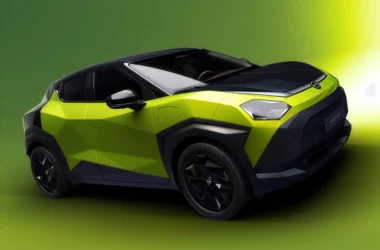 Front three-quarter view of the Nissan Juke EV in lime green and black, featuring low-poly faceted body panels and sharp geometric headlights.