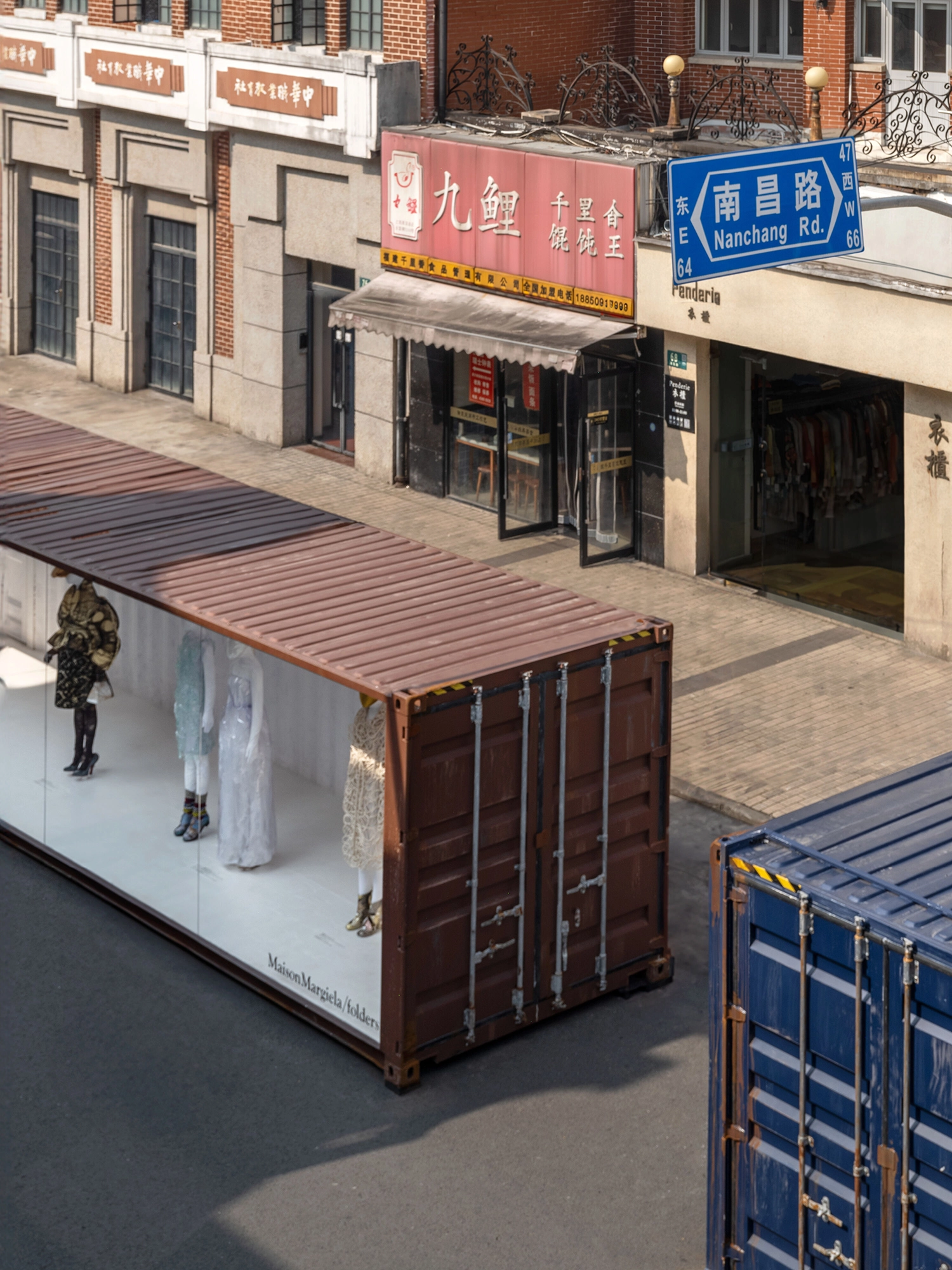 Bird's-eye view of a burgundy shipping container exhibition unit on Nanchang Road in Shanghai.