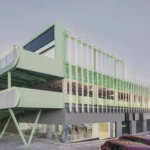 Exterior view of Leganés Auto Center featuring a mint green ramp and perforated metal facade in Madrid.