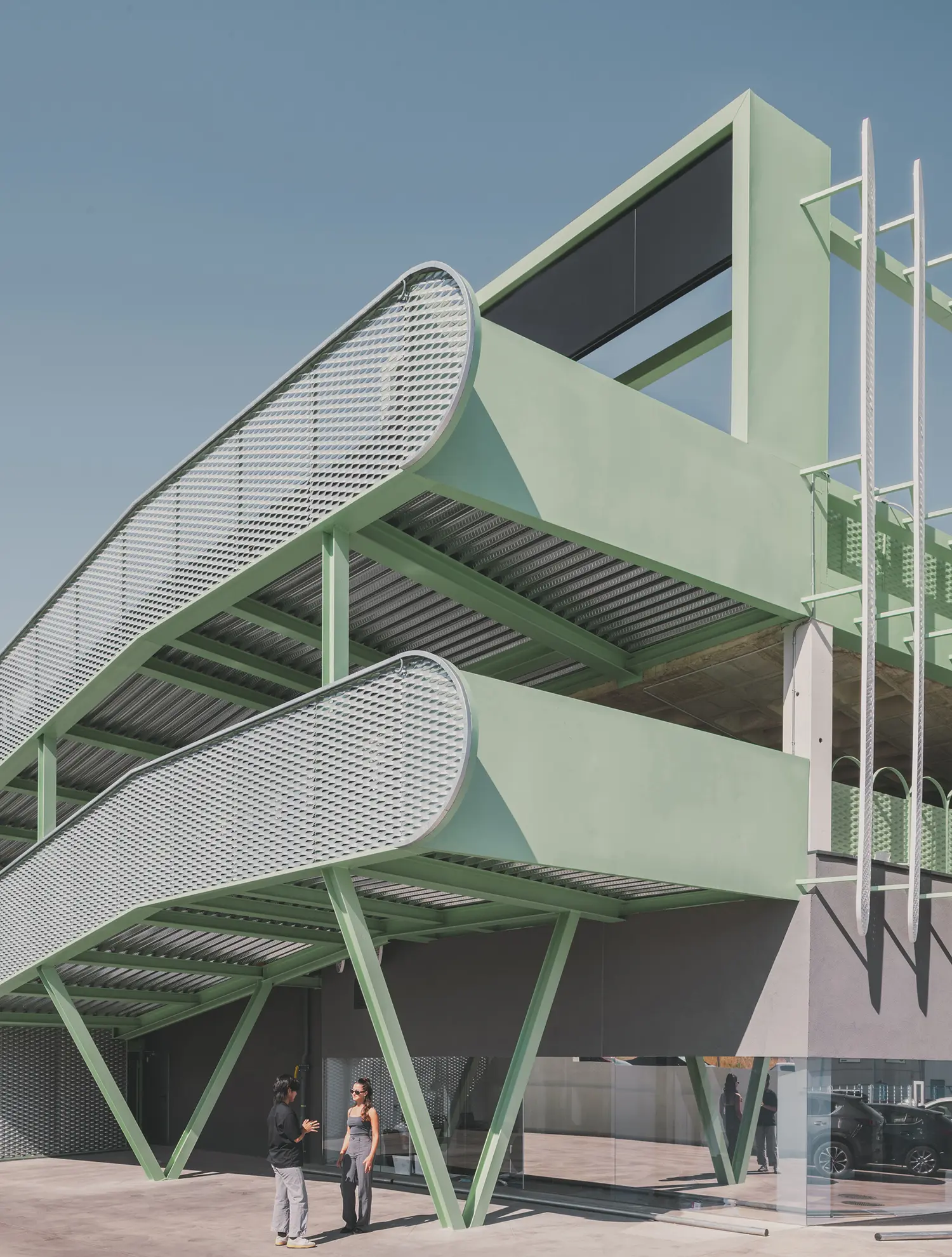 Detail of the mint green ramp structure and steel supports at Leganés Auto Center.