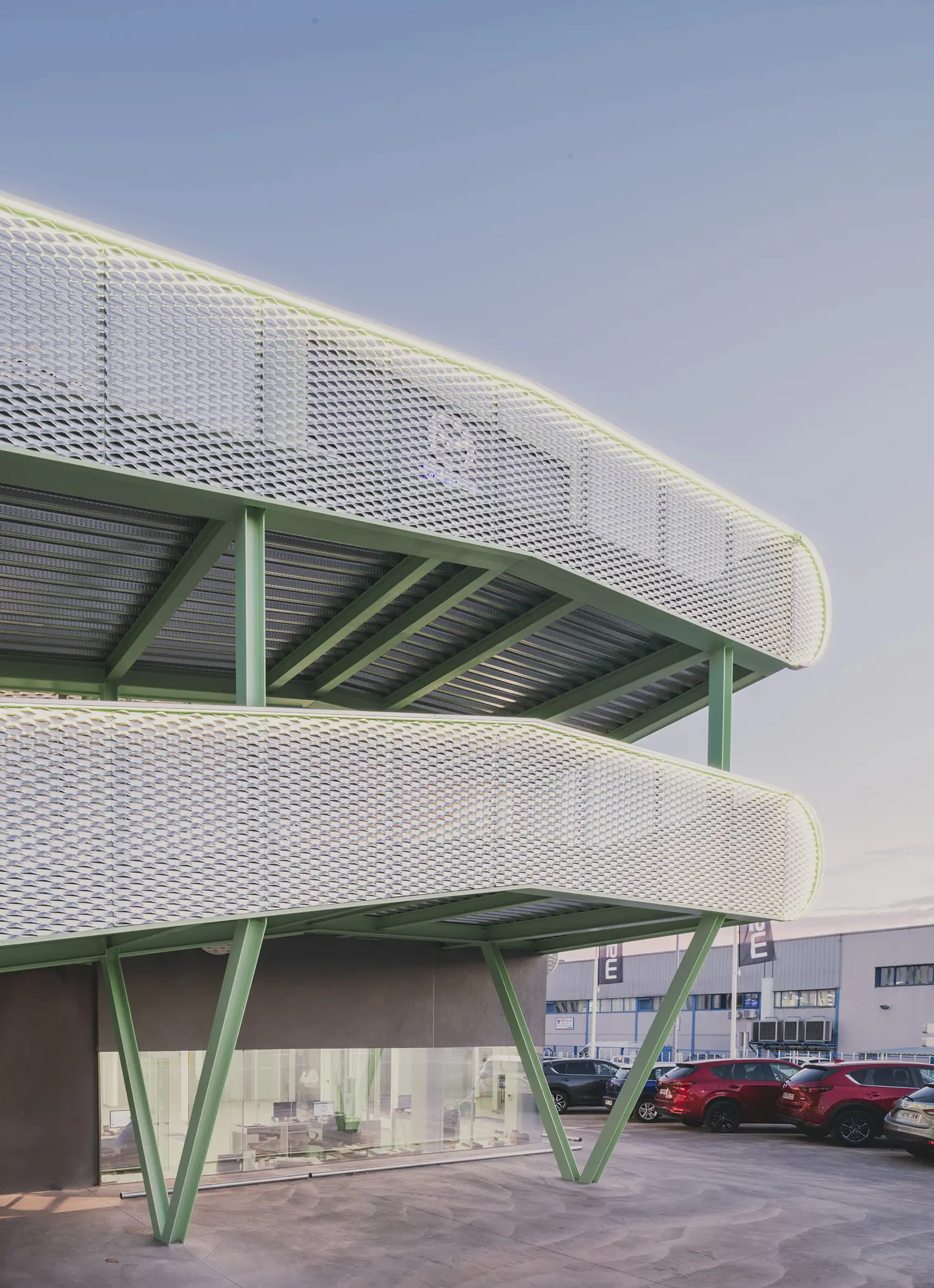 Close-up of the curved mint green ramp levels with perforated metal cladding.