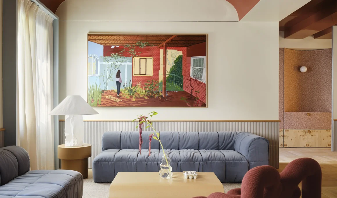 Modernist living room in Madrid with a burnt-orange vaulted ceiling, blue modular sofa, and large contemporary painting.