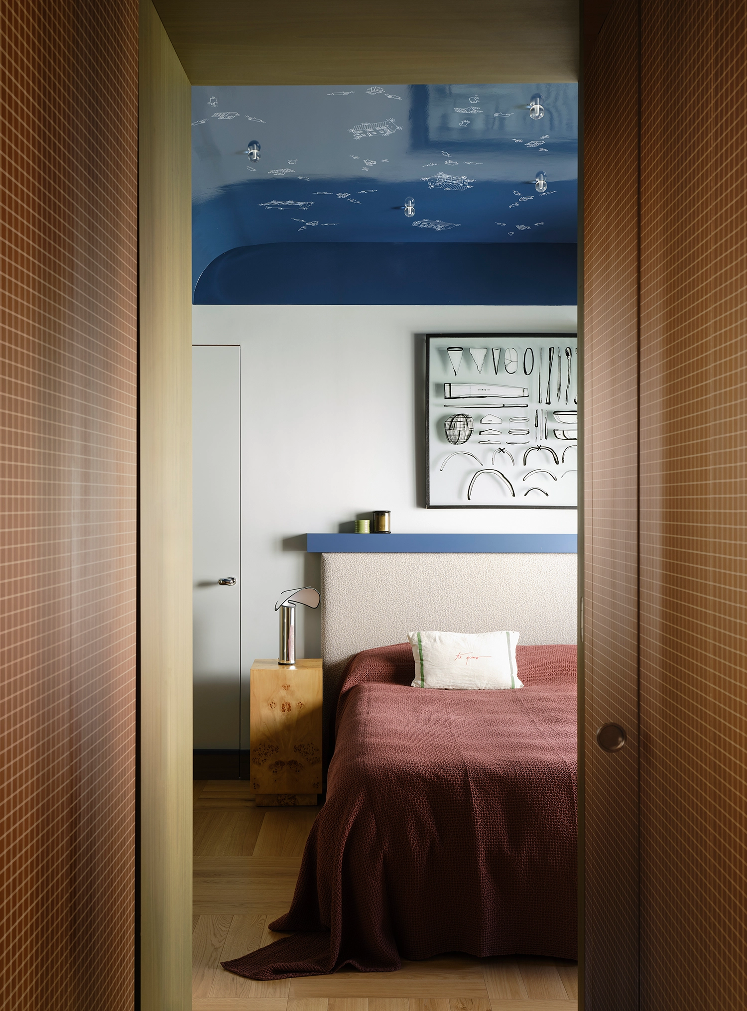 Master bedroom with a midnight blue ceiling featuring hand-painted white constellations and integrated star-like bulbs.