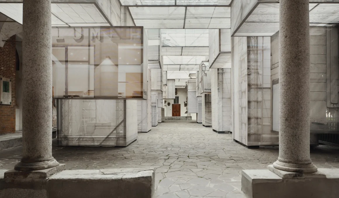 A perspective view of The Factory of Light installation featuring translucent scaffolded walls within a stone courtyard.