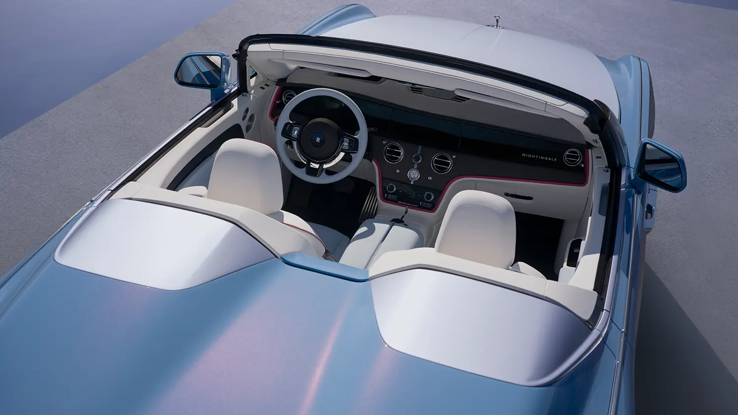 High-angle shot of the Project Nightingale cockpit with white and blue leather seats and Navy inserts.