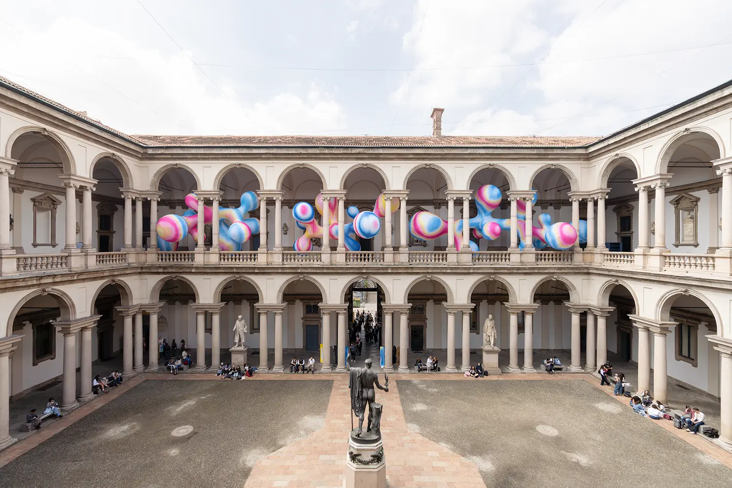 Symmetrical wide shot of the Brera courtyard during Milan Design Week 2026 with the Serotonin installation.