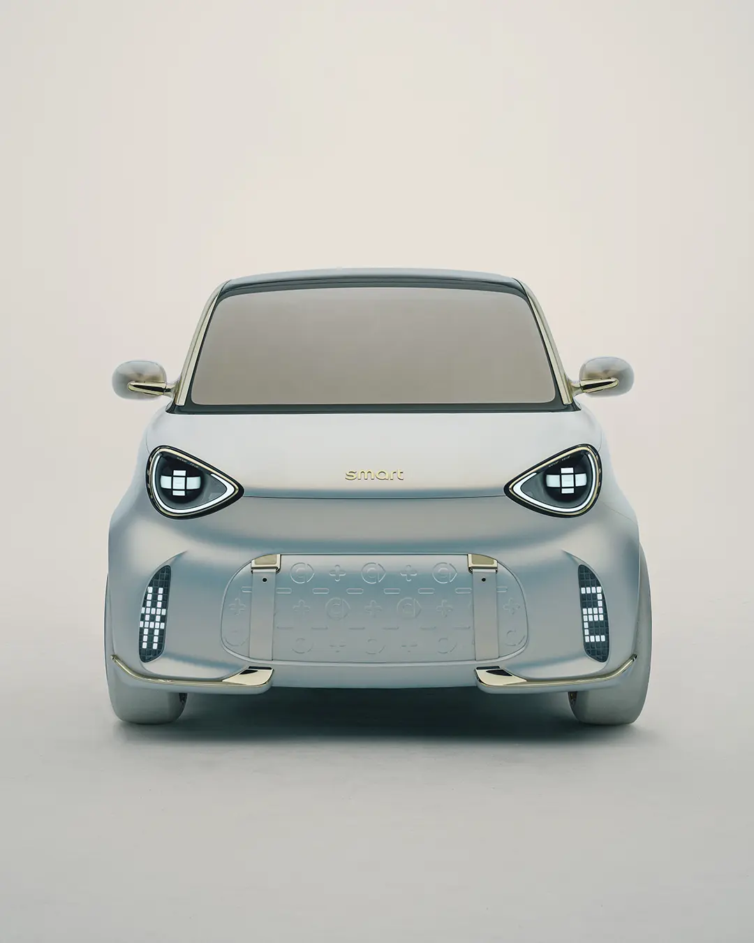 Frontal view of the smart Concept #2 electric vehicle showing the symmetrical face, gold "smart" lettering, and textured front panel.