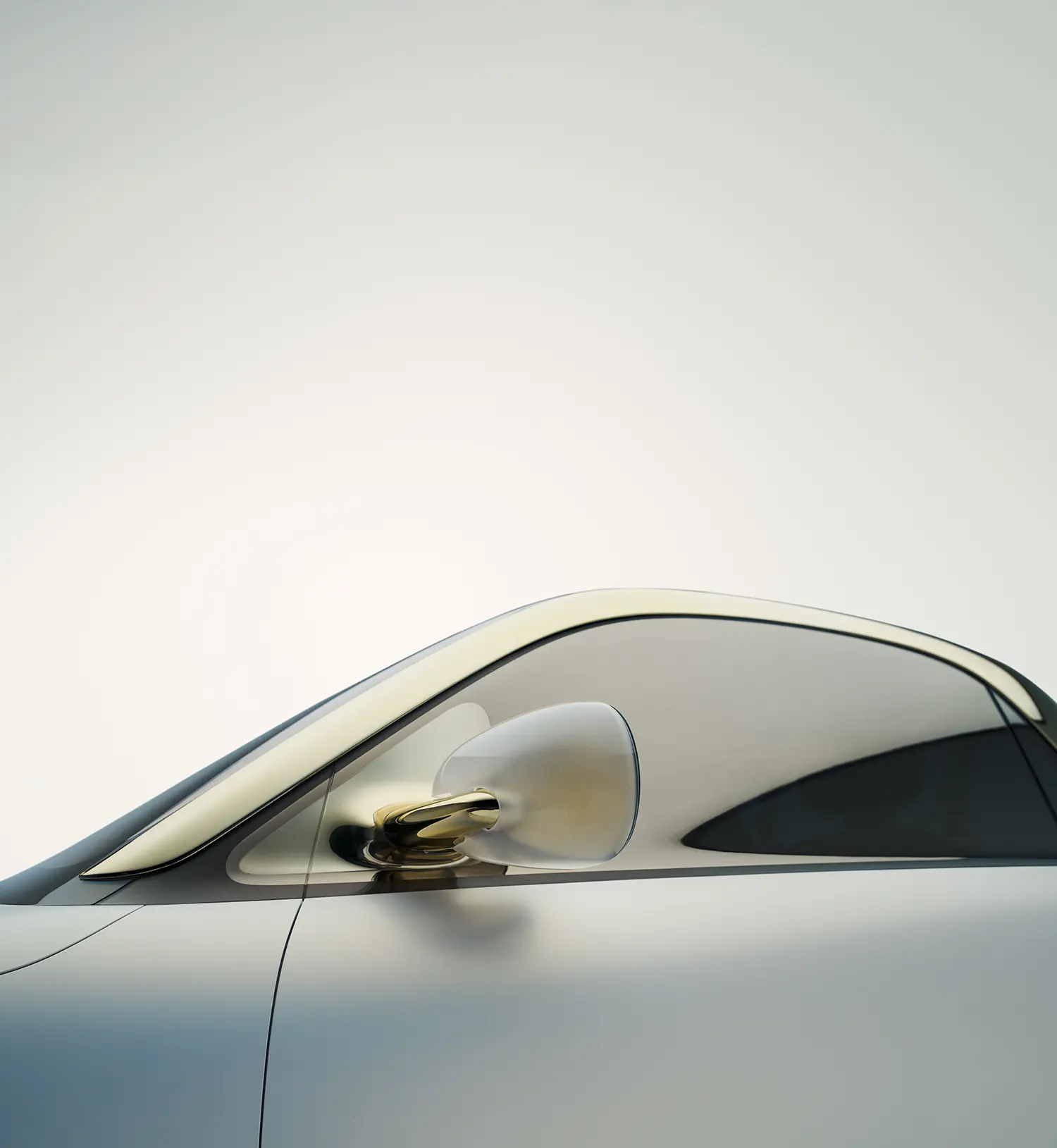Macro detail of the smart Concept #2 roofline and side mirror in warm gold and translucent finishes.