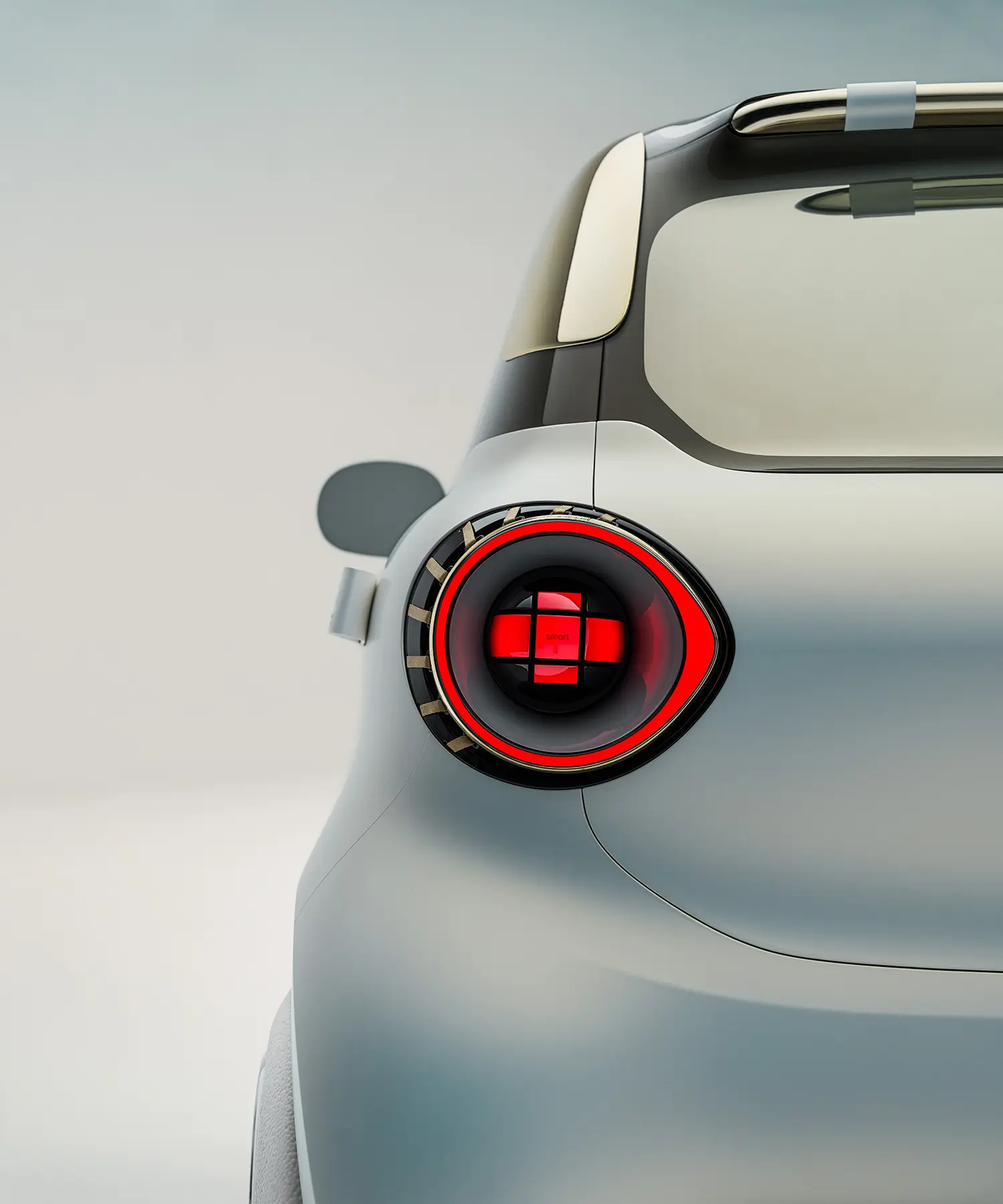 Rear detail of the smart Concept #2 showing the circular LED taillight with a red cross-motif signature.