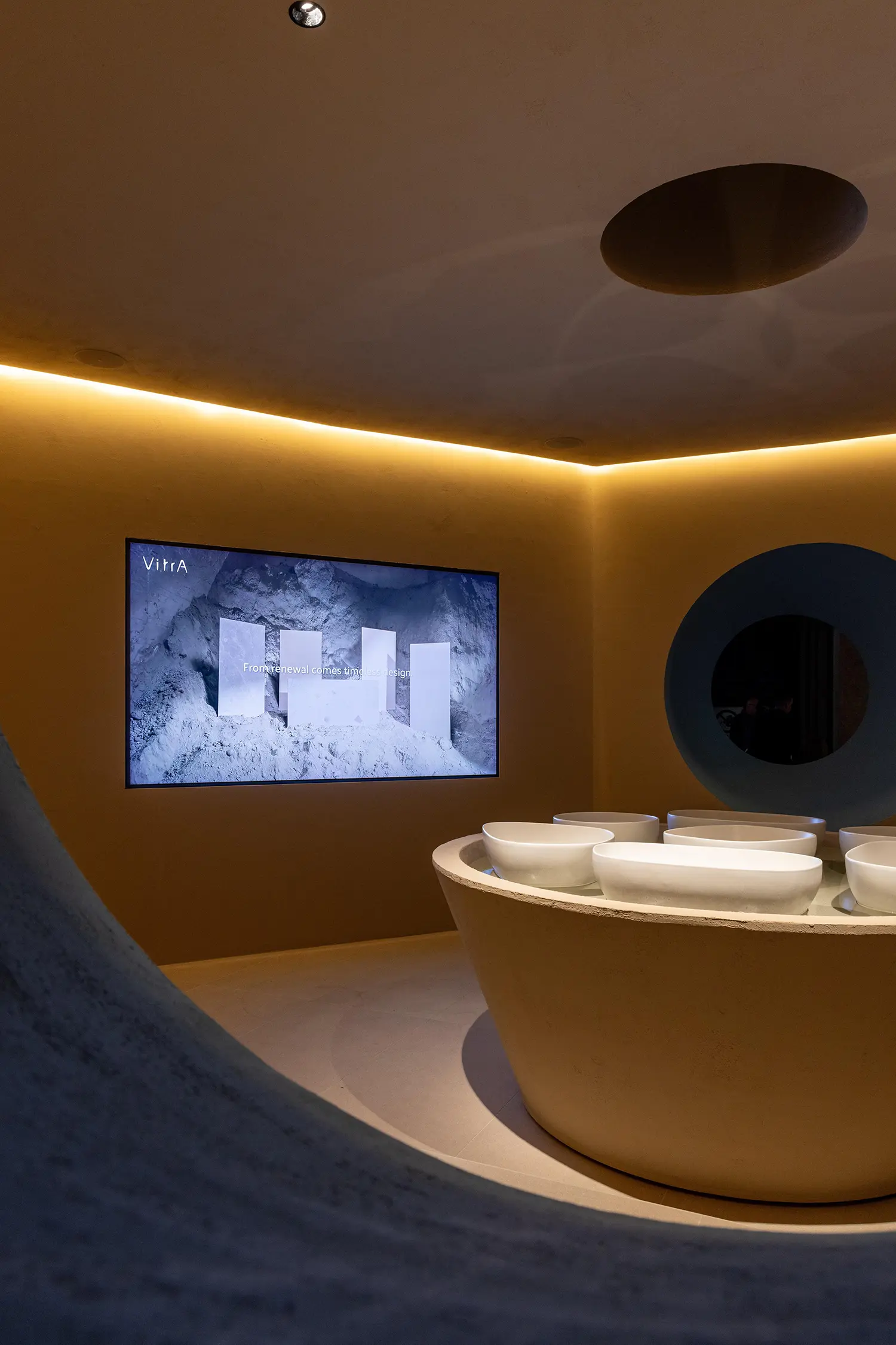 Wide interior view showing the main exhibition basin under circular lighting.