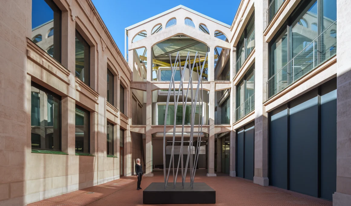 Wide shot of SpY's DISLOCATION kinetic sculpture in the Serrería Belga atrium, Madrid.