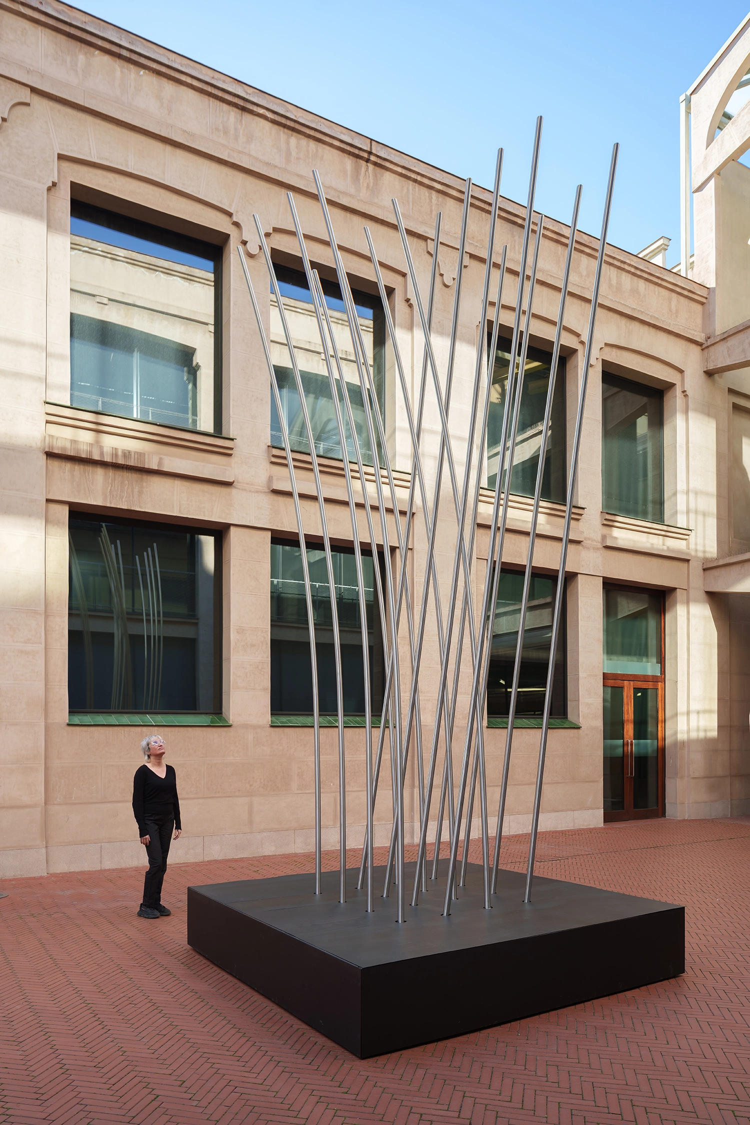 Perspective shot of SpY's kinetic sculpture showing the wide base and spreading slats.
